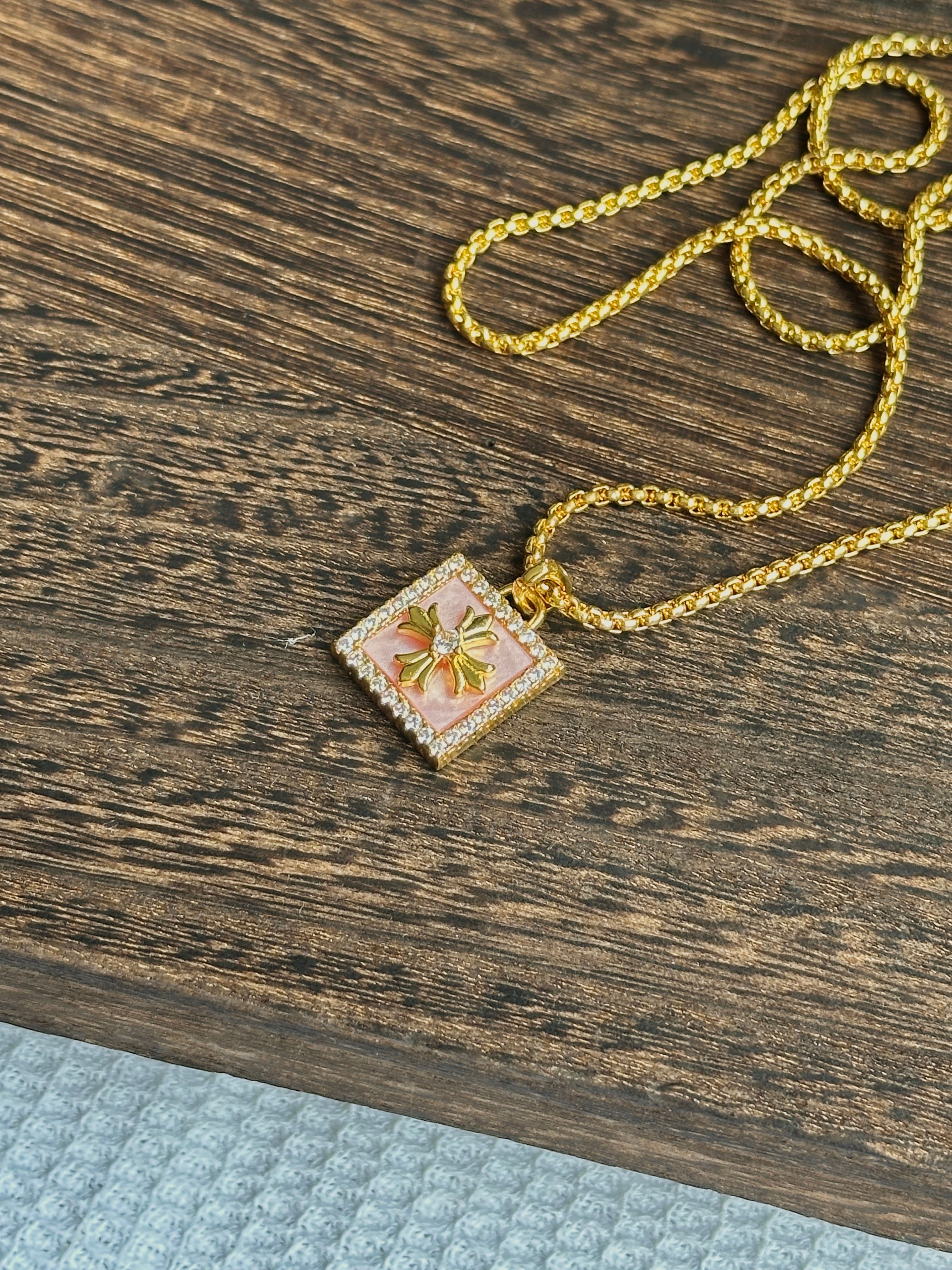 Gold compass pendant with pink enamel accent, dainty and layerable