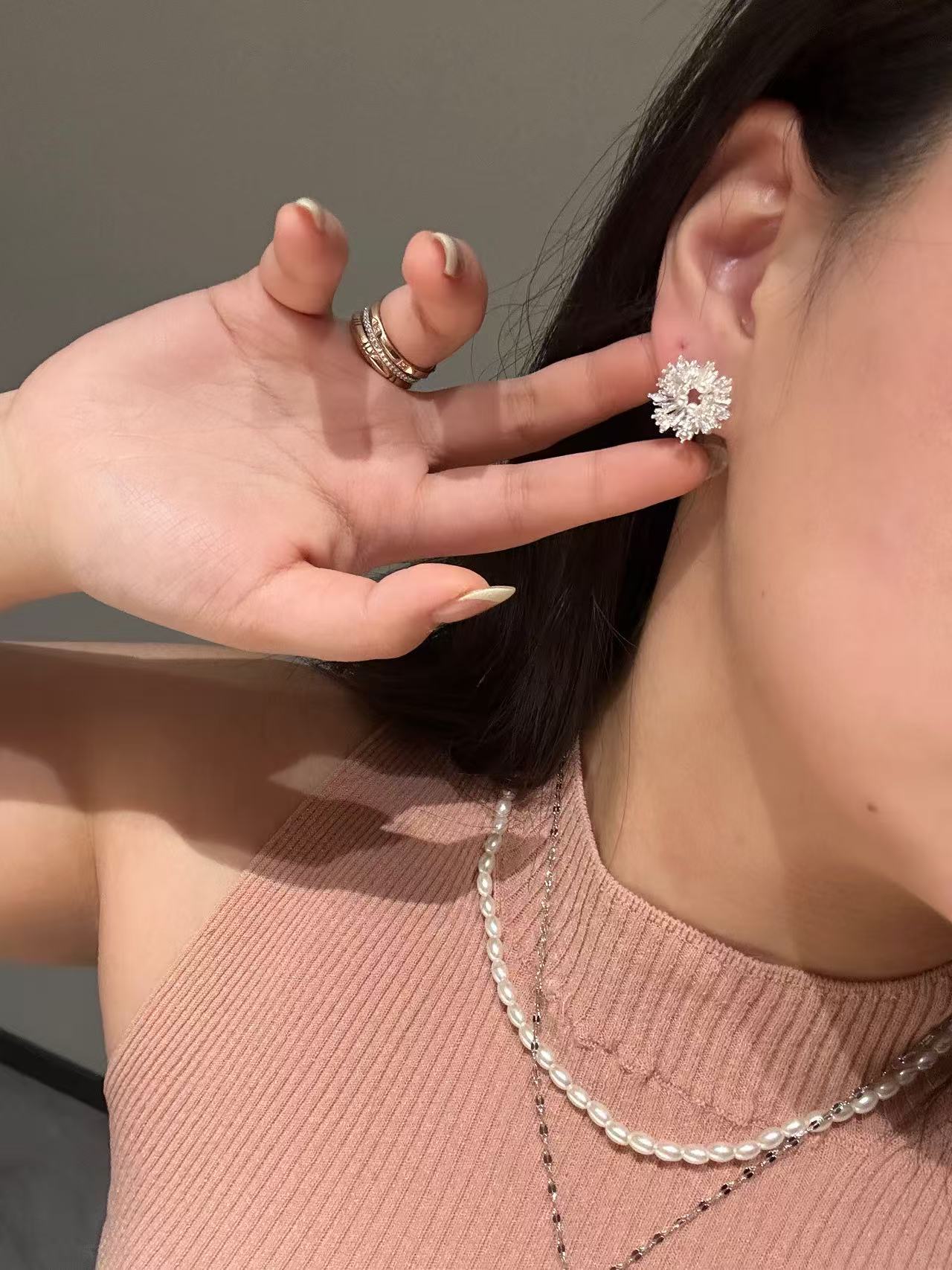 On-ear shot: silver firework earrings, stainless steel, nickel-safe